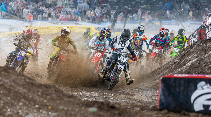 A pack of riders kicking up mud at the East Rutherford AMA Supercross event